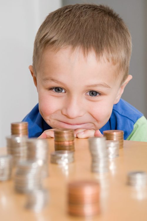 boy-looking-at-stacks-of-coins-2026-03-26-11-55-41-utc